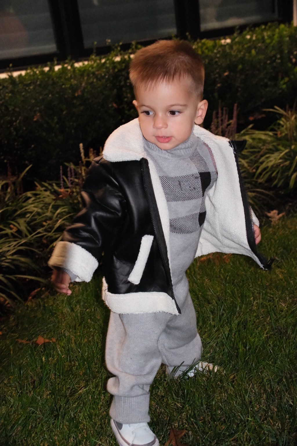 Jamie modeling the black fleece-trim jacket with his gray sweater and pants