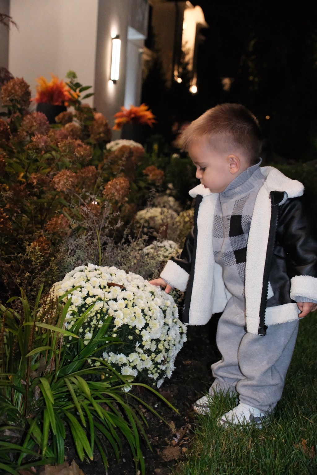 Jamie modeling the black fleece-trim jacket with his gray sweater and pants