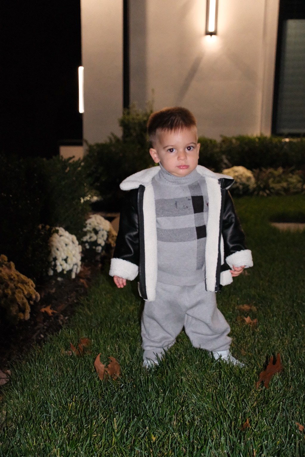 Jamie modeling the black fleece-trim jacket with his gray sweater and pants